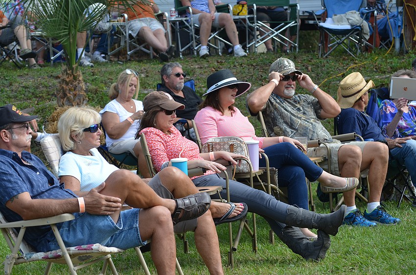 Attendees listen to bluegrass music after snacking on gumbo.
