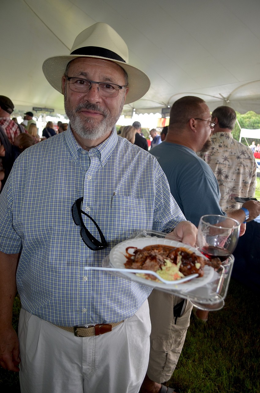 Mark Lowry, of Bradenton, samples food and wine.