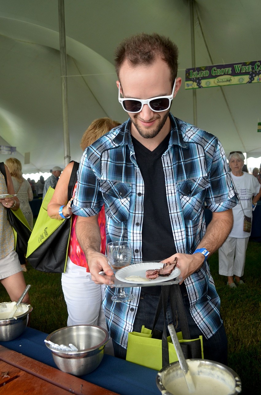Justin Elliott, of Tampa, tries a range of meat dishes.