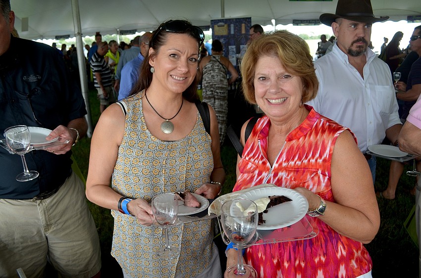 Laura Williams, of GreyHawk Landing, and Diane O'Connor, of Eagle Trace, dive in to a range of food samples.
