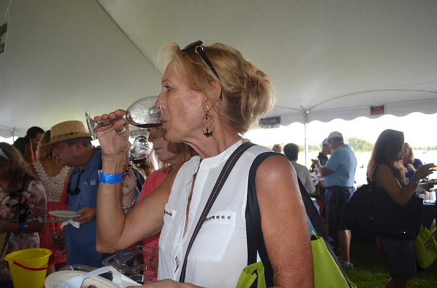 Sherlie Bente, of Lakewood Ranch, enjoys a glass of red wine.