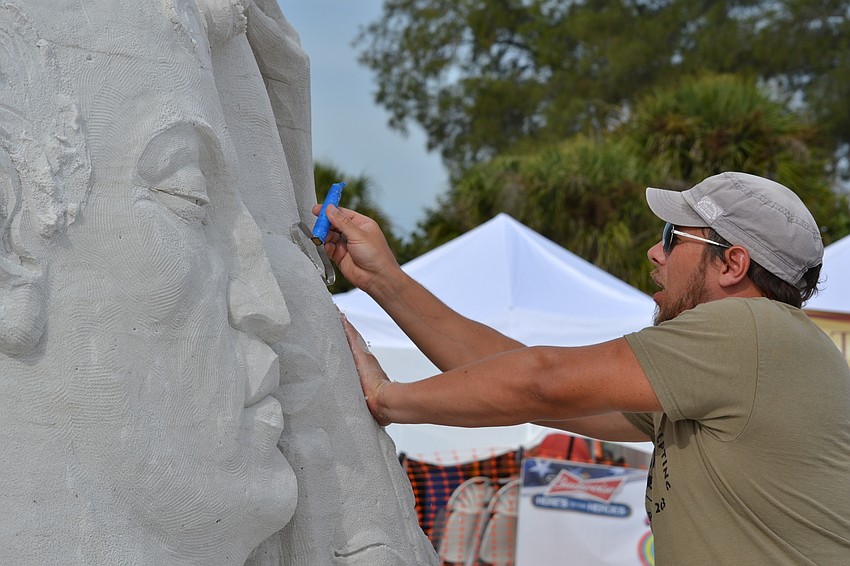Illya Filimontsev smooths out the surface on his sculpture.