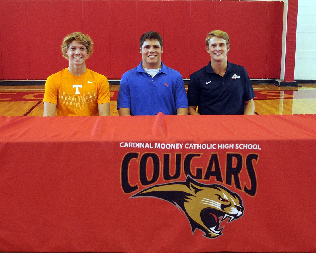 Cardinal Mooney seniors Matt Garcia, Reagan Griffith and Taylor Garris all signed scholarships Nov. 11.