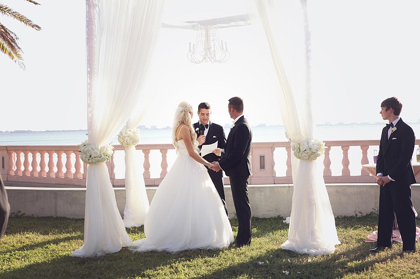 The couple was married under a custom-built canopy near the water on the New College lawn. (Photo Credit: Katie Beyer Photography)