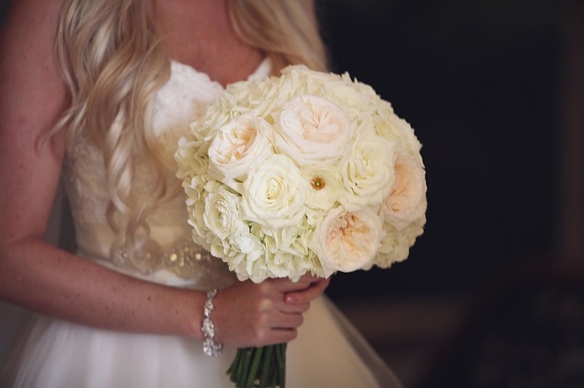 Floral designs were all-white flowers by Elegant Designs. (Photo Credit: Katie Beyer Photography)