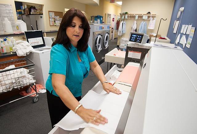 Cheryl Walstad, pictured, and her husband, Dave, are opening their second All Star Laundry location in Lakewood Ranch and will have a third in 2016.