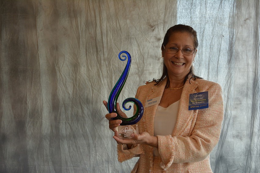 Ray of Sunshine winner Maria Hussey of Juvenile Diabetes Research Foundation, shows off her Sandie Award.