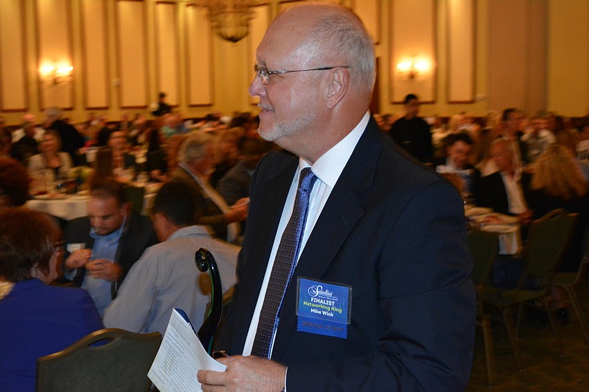 Mike Wick of Gator Air Conditioning & Plumbing carries off his Networking King Award.