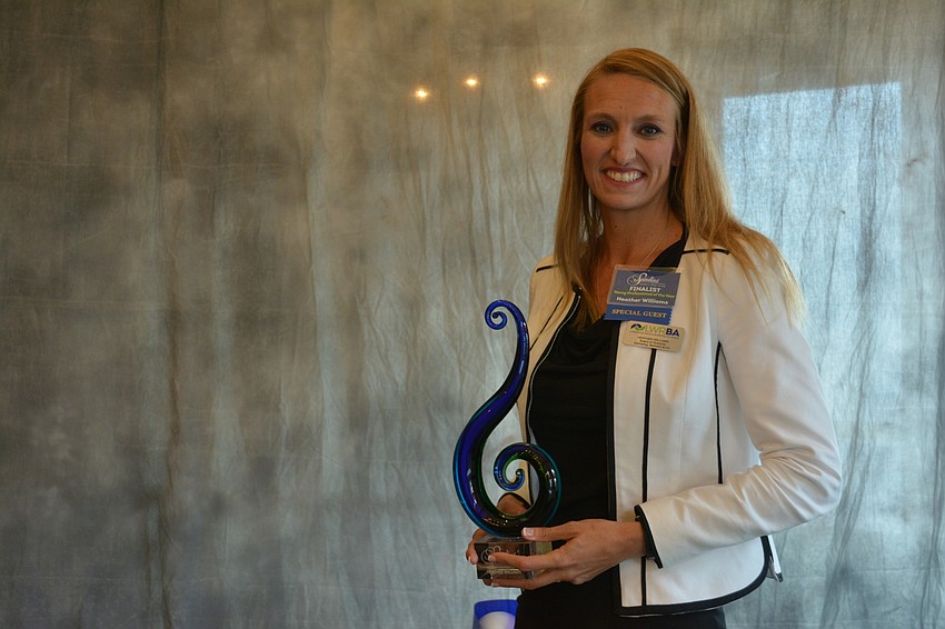 Heather Williams of Kerkering, Barberio & Co., poses with her Young Professional of the Year award.