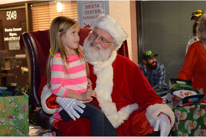Lexy Friedman tells Santa what she wants for Christmas following the 2014 Light Up the Village parade in Siesta Key.