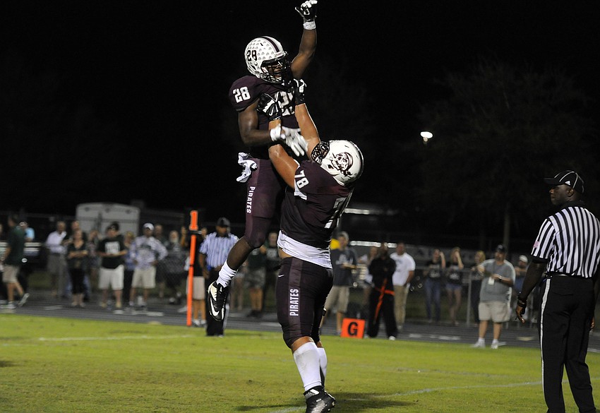 Braden River running back DeShaun Fenwick and offensive lineman Alex Salguero celebrate following Fenwick's touchdown run in the second quarter.