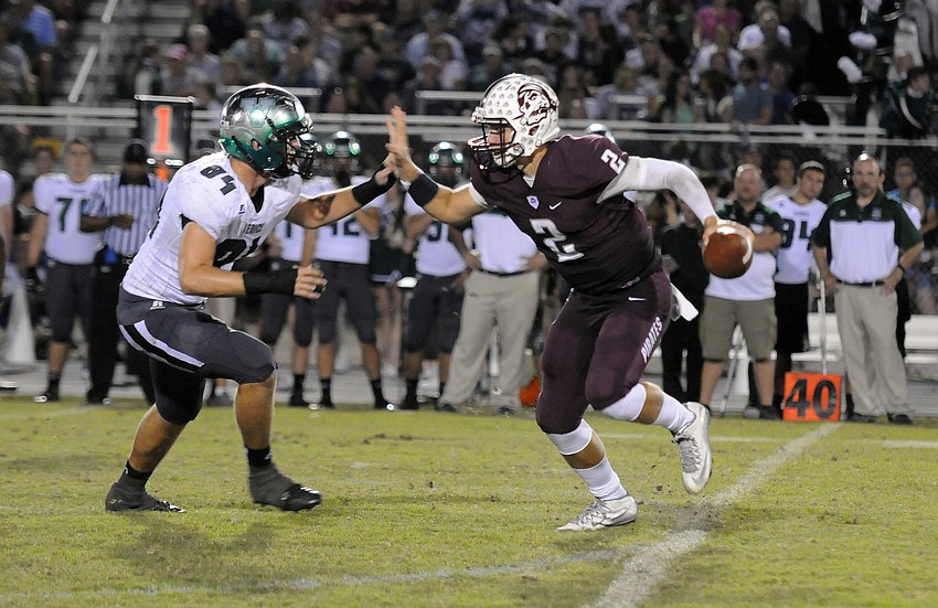Braden River quarterback Jacob Huesman scrambles for yardage in the third quarter.