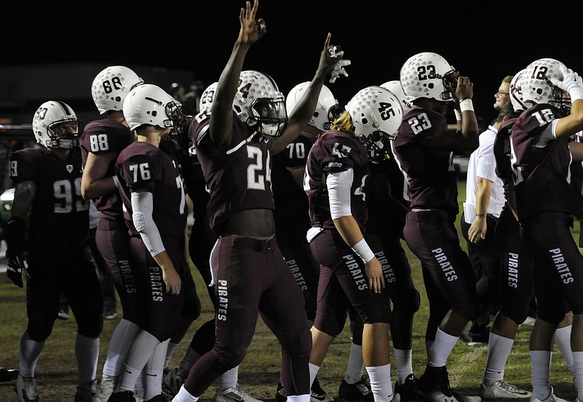 Braden River linebacker Paul Wiggins holds three fingers in the air after the Pirates clinched a berth in the regional final.