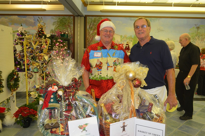 Russ Gill and Jim McGuire sell raffle tickets for St. Mary Men’s Club.