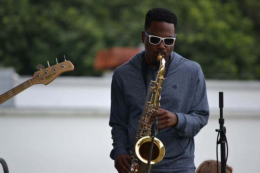 Justin Green of Jah Movement performs the saxophone.