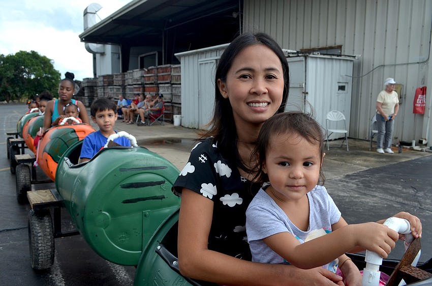 Tai and Ava Cholakian, of Sarasota, go take a ride to the groves.