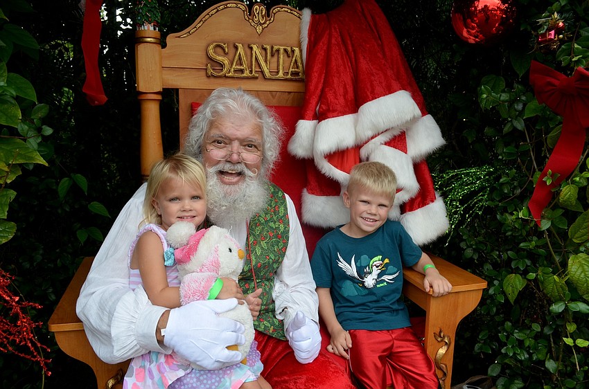 Ailey Moore, of Bradenton, poses with Santa and her brother, Waylon.