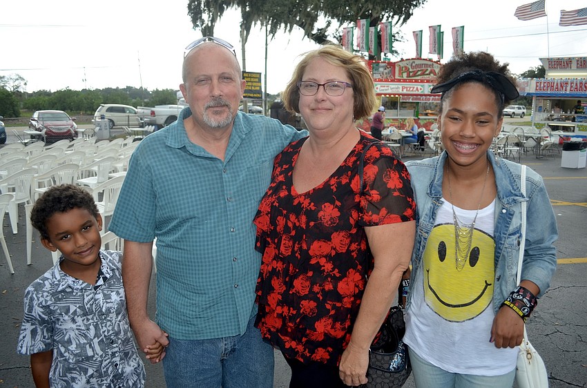 Kendrick Tolbert, Charlie Braust, Pam Morris and Sarai Peavy, of Bradenton, enjoy live music before the rain starts.