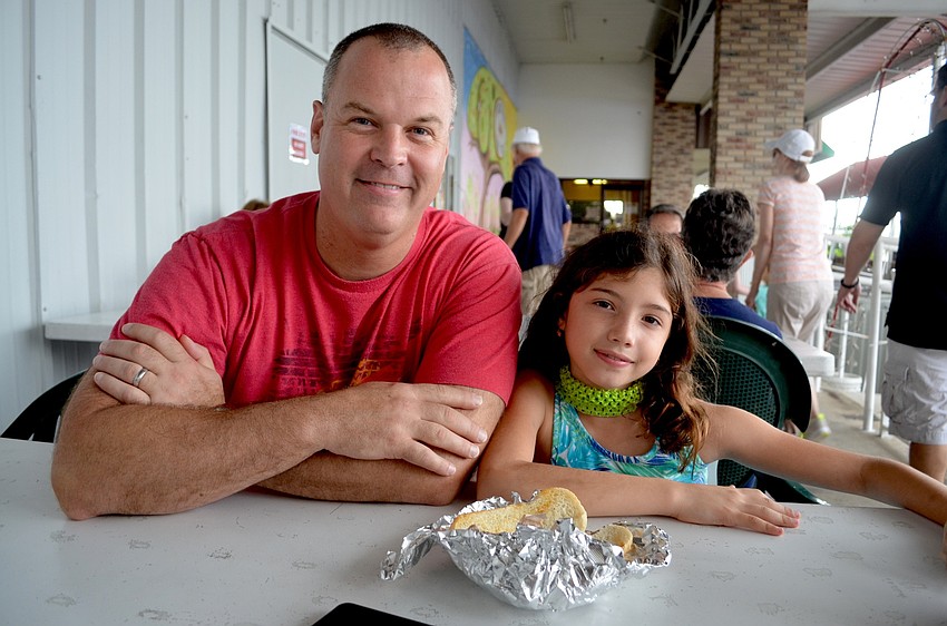 Matt Seiler and his daughter,  Sophia, of Bradenton, take a quick snack break.