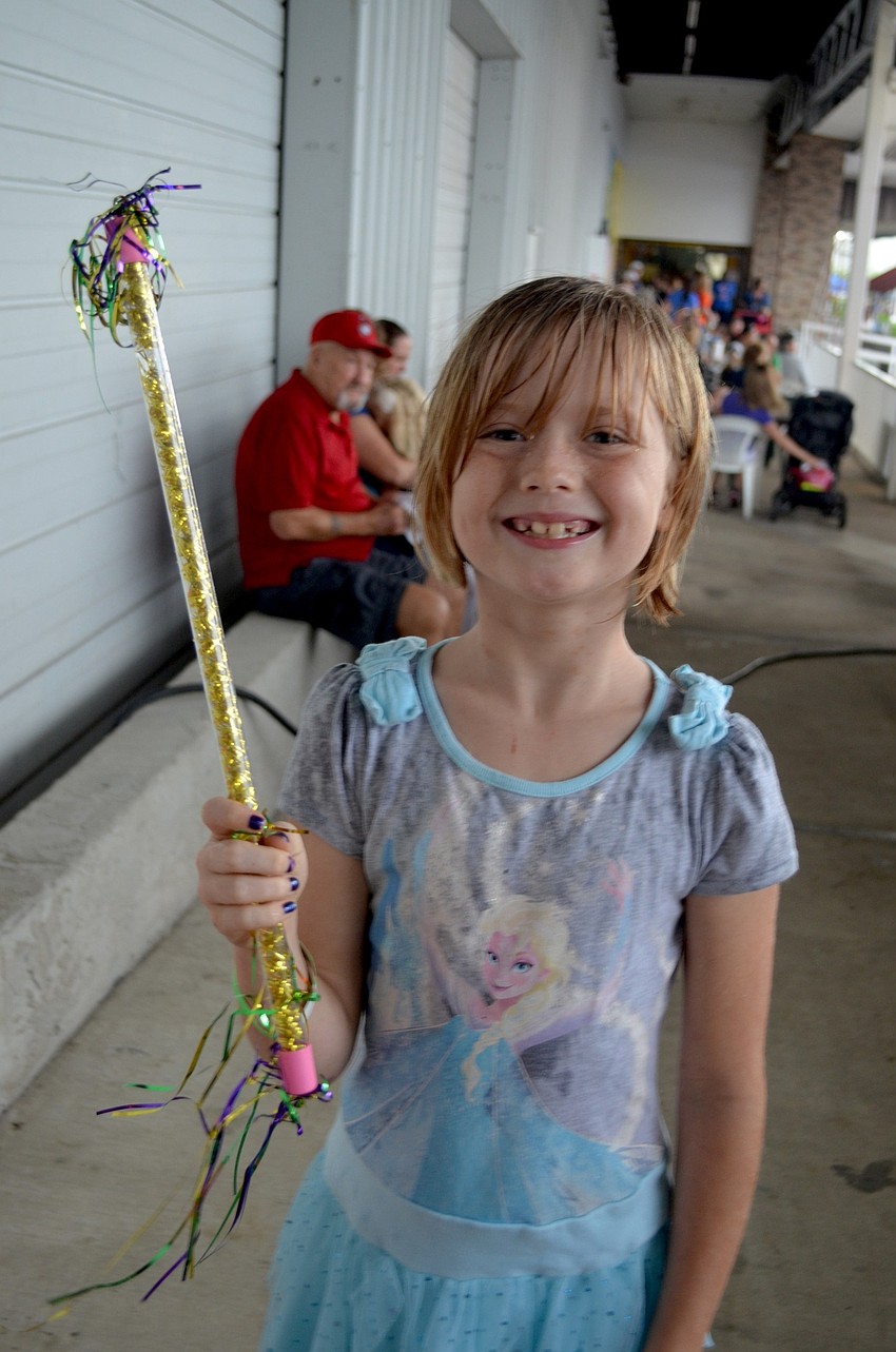 Eight-year-old Elise Combs, of Sarasota, shows off her newest toy.