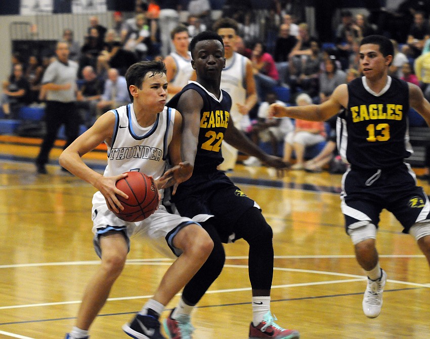ODA sophomore Chase Maasdorp attempts to drive past Sarasota Military Academy's Maurice Cook.