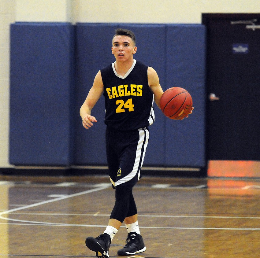Junior Shelby Rhodes brings the ball up the court for Sarasota Military Academy.
