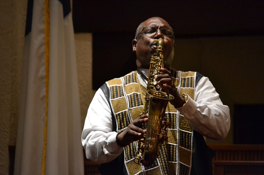 John Walker from Bethel Christian Methodist Episcopal Church Gospel Choir performs on the saxophone