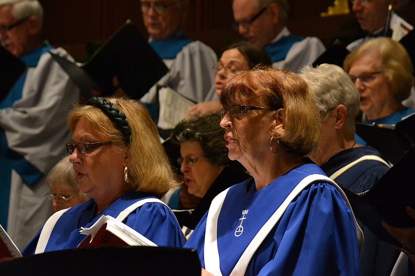 Veronica Schoenwolf and Chris Normann perform with choir that included multiple congregations.