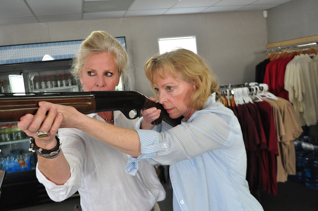 GRITS founder Elizabeth Lanier helps Dyana Goss with her shooting form.