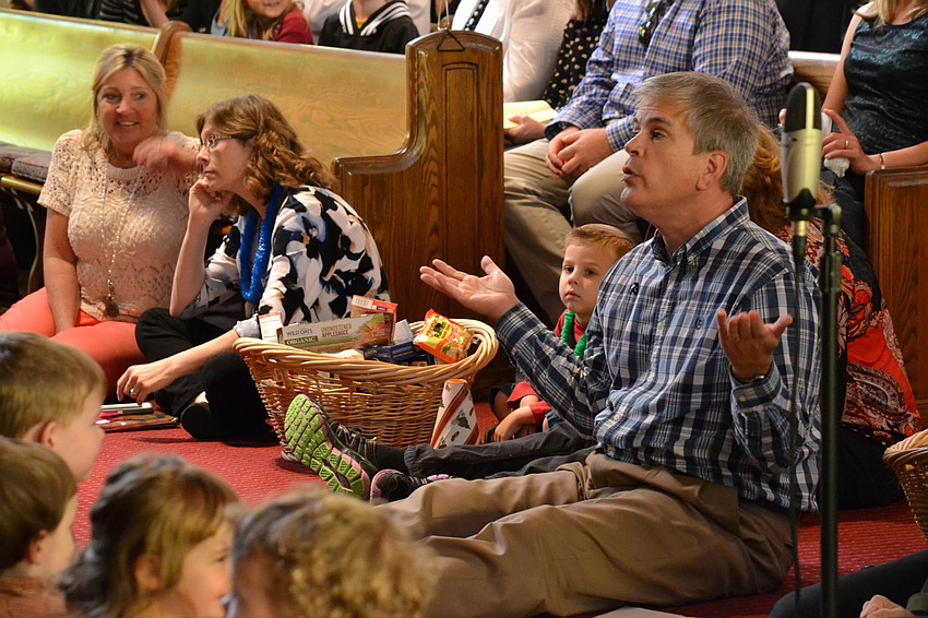 Rev. Glen Bell explains to children Thanksgiving traditions and reasons to be thankful.