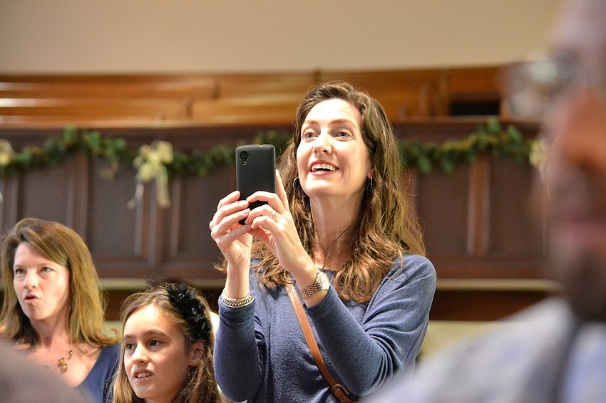 Susan Yancey tries to capture footage of her daughter Juliet Yancey during a performance by First Presbyterian Preschool students Monday morning.