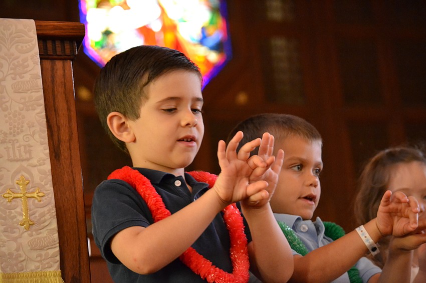Trey MacDougall follows along with the performance at First Presbyterian Church Monday morning.