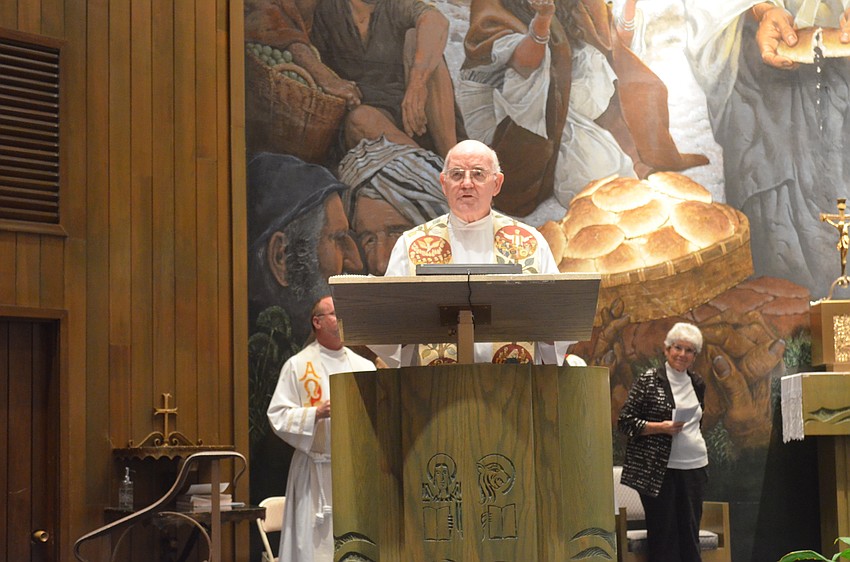 Msgr. Gerry Finegan, of St. Mary, Star of the Sea, Catholic Church, gives the welcome and invocation.