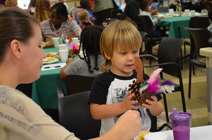 Jackson Zimba plays with the turkey decorations.