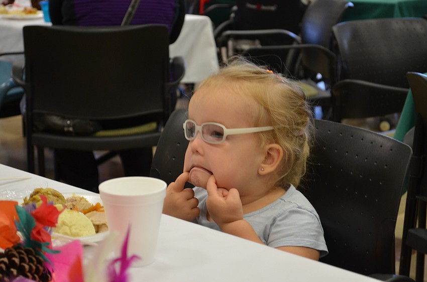 Makayla Laney makes a silly face during the Pines of Sarasota Thanksgiving luncheon.