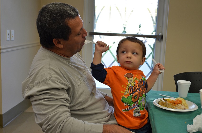 Corbin Mendes feeds his father Ray a bite.