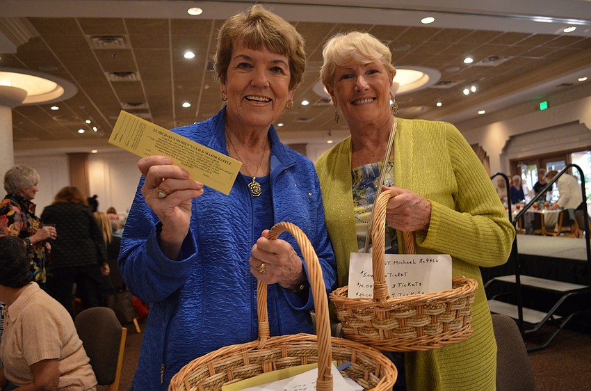 Eileen Ishmael and Sally Karanzas sell raffle tickets before the fashion show.
