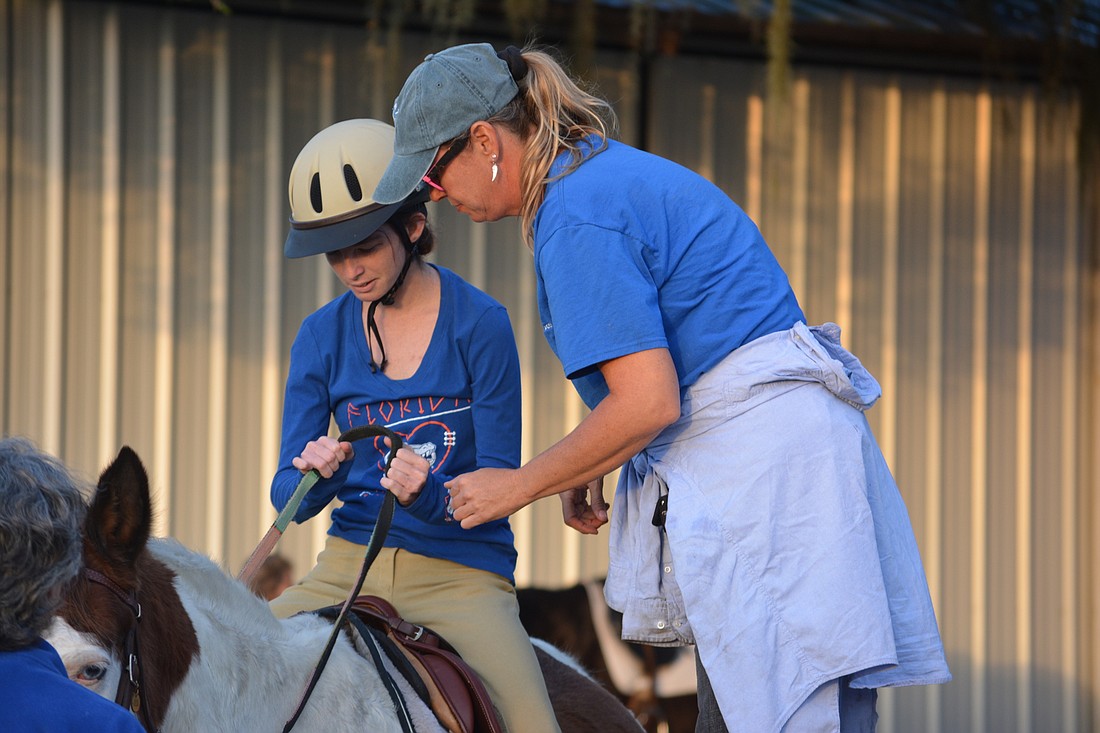 Brittany Bouldin gets some tips about riding P.J. from SMART barn manager and instructor Samantha Toomey.