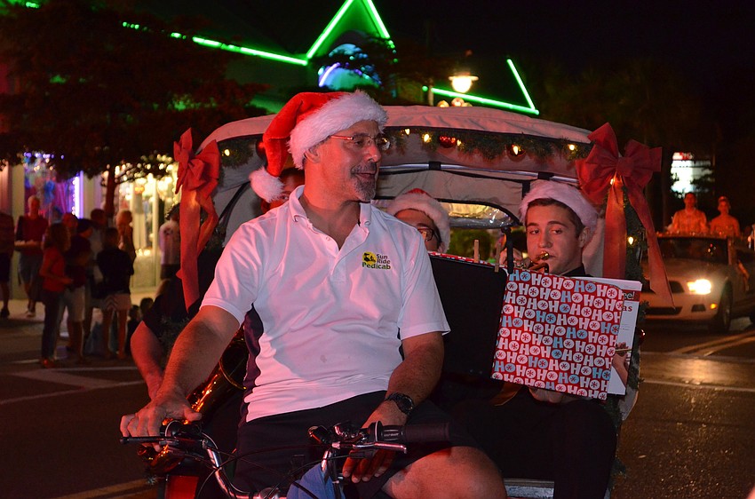 Glen Cappetta of Sun Ride PediCab pedals along the parade route with members of the Pine View Jazz Trio playing along.