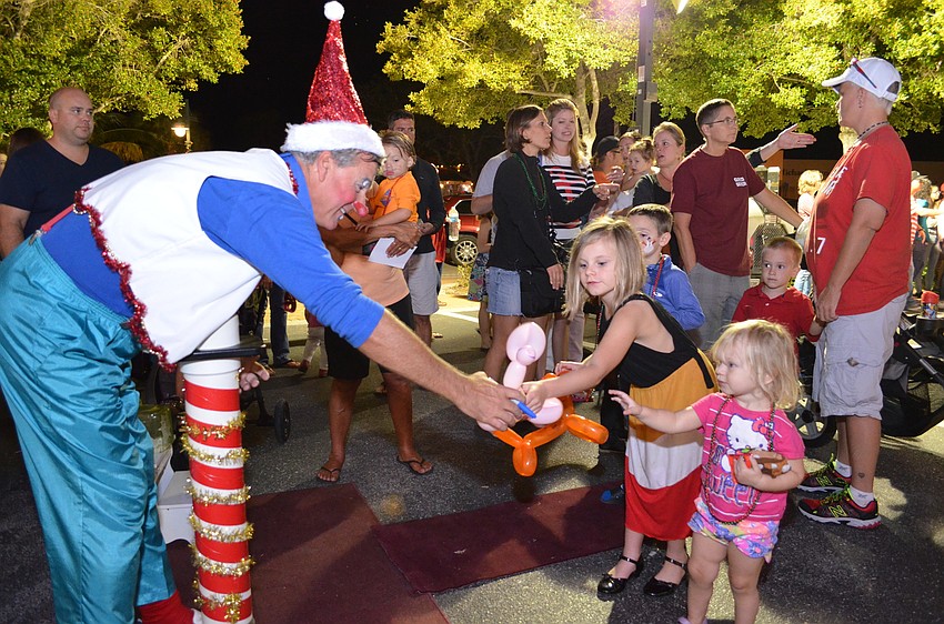 Sunshine the Clown or Scott Gregory made balloon animals for children waiting in line at Santa's Village.