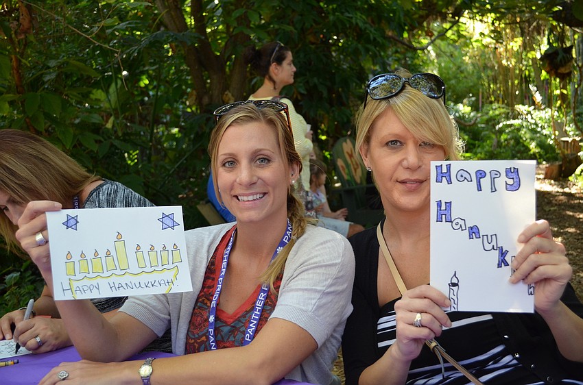 Ashley Swenson and Carrie Mandell show off their cards they made for Hanukkah.