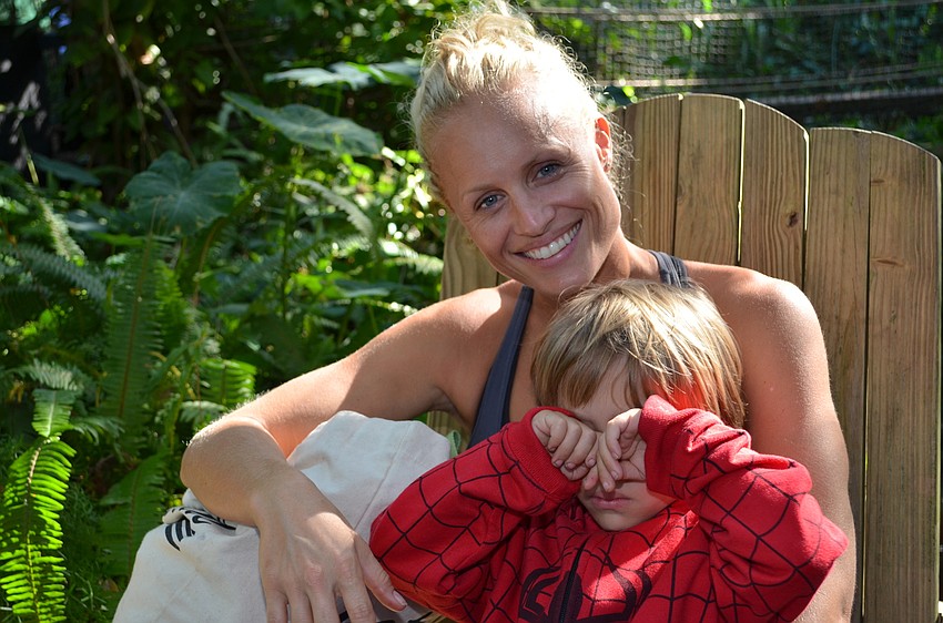Kelli Jaco smiles while Joshua Jaco shies away from the camera.