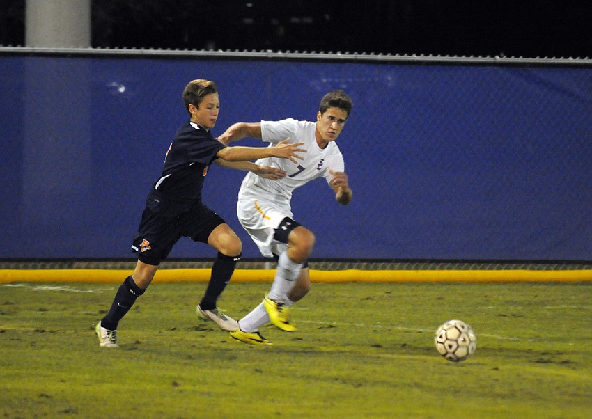 Sarasota Christian's Tanner Stutzman battles a Bradenton Christian defender for possession.
