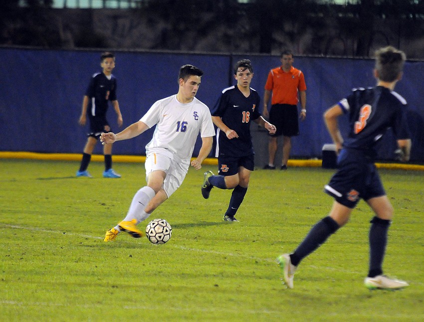 Sarasota Christian midfielder Garrett Mullenax maneuvers the ball up the field.