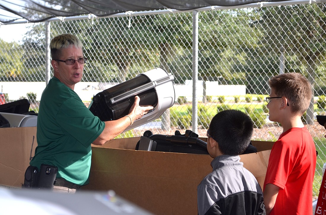 Cari Walz, Household Hazardous Waste employee, explains to East County students what happens to electronics that are thrown away.