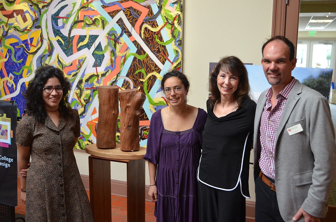 Celia Garcia Nogales, Irene Garibay, Nancy Markle and Jeff Schwartz stand next to a one-eighth model for Nogales and Garibay's winning statue design, which will be erected southwest of the college's new library in the summer of 2016.