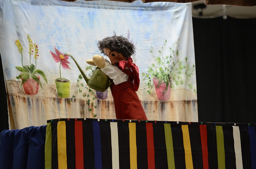 Susana Abell performs a puppet show about a gardener.
