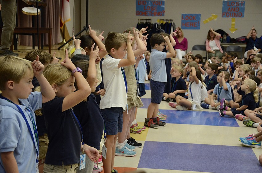 Laurie Rahn's first-grade class show their fellow schoolmates how to do the movements to the unicorn song.