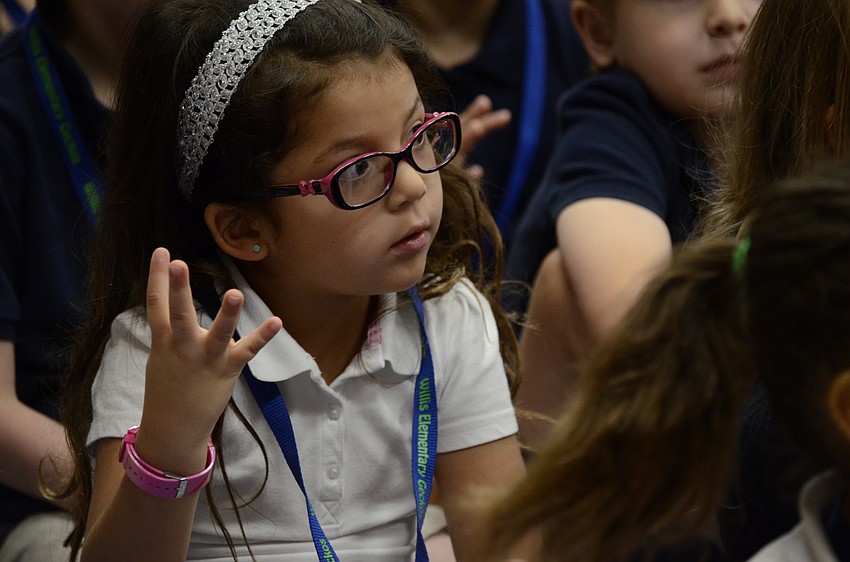 Valentina Suarez counts the transportation methods during Timmy Abell's travel song.