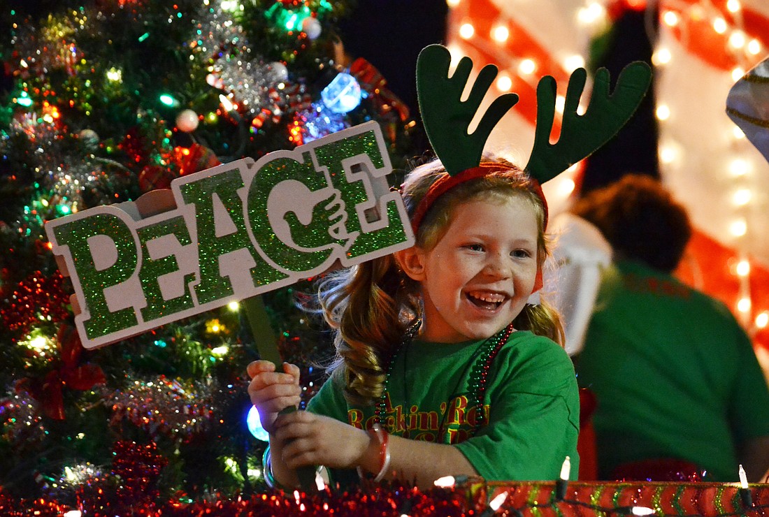 File photo. Grace Hullinger promotes peace on Earth from the float for the Sarasota Tabernacle Christian School Saturday, at the Downtown Sarasota Holiday Parade in 2014.